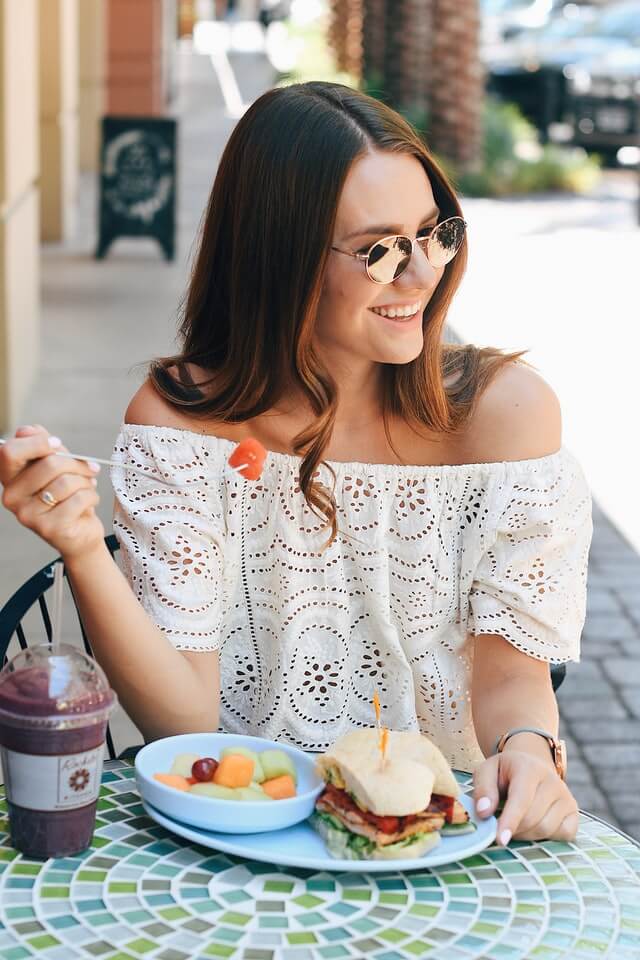 woman eating a healthy fruit salad