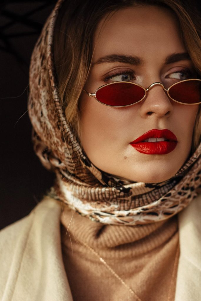 woman wearing red lipstick, makeup and red glasses