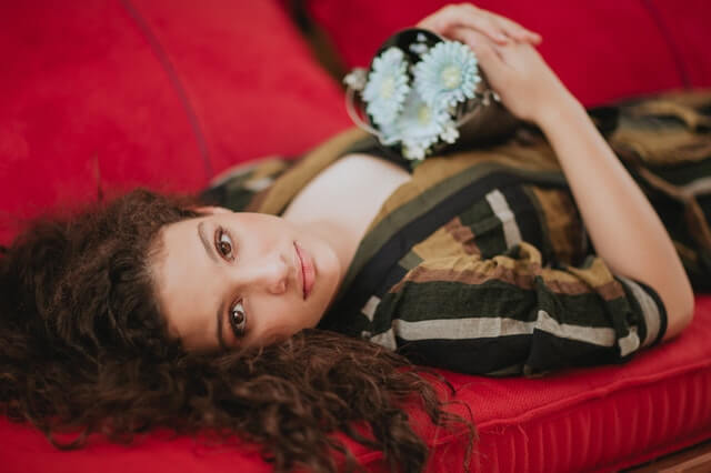 woman lying on the bed with flowers