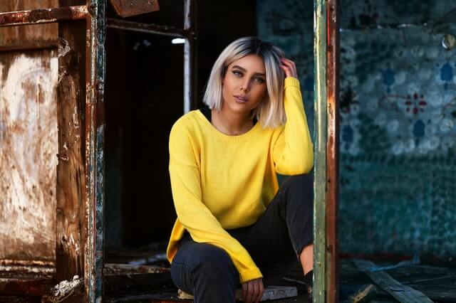 blond hair, yellow blouse and stylish pants