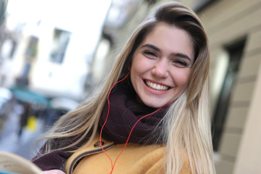 girl with blonde hair listening to music