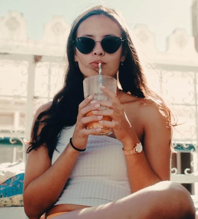 woman with long hair drinking