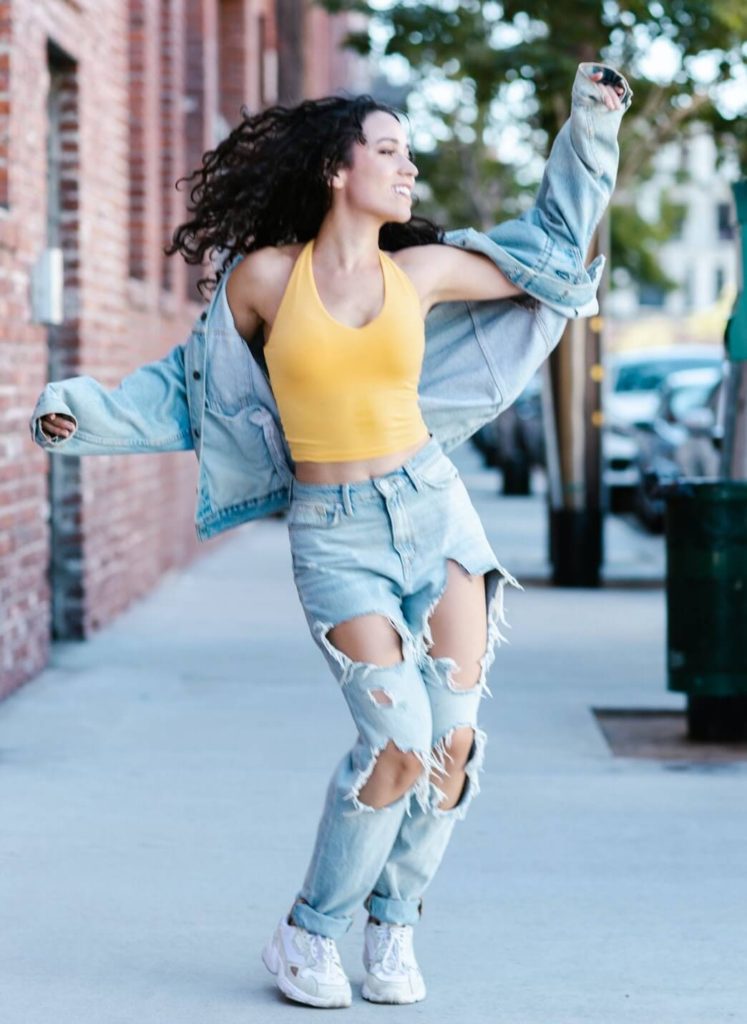 woman dancing in fashionable ripped jeans (1)