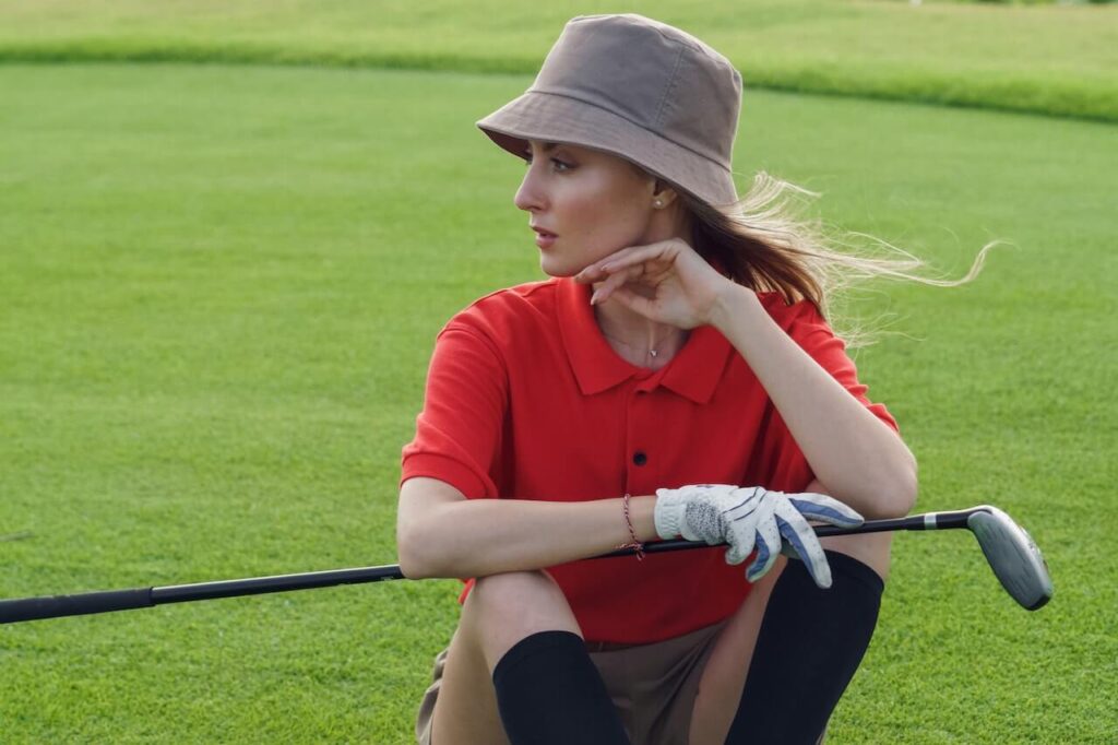 woman with red shirt playing golf