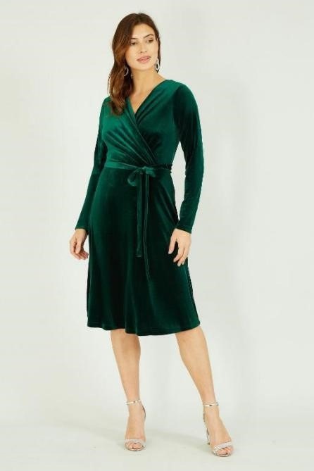 woman wearing a green velvet dress