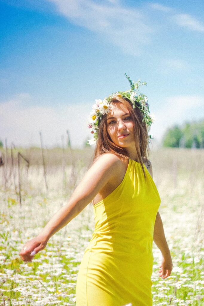 woman in a field wearing yellow dress
