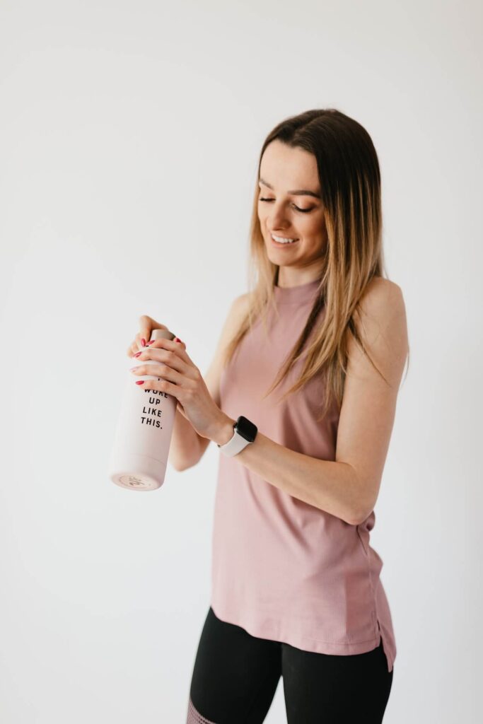 woman in a pink shirt drinking a shake