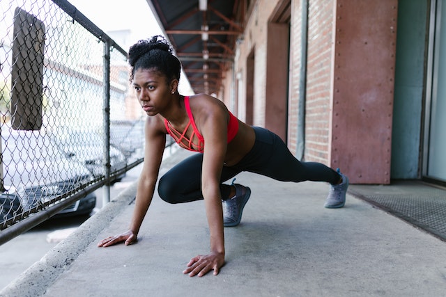African-American woman stretching outside