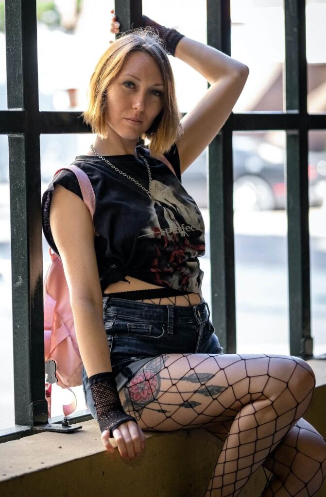 woman wearing fishnets with denim shorts